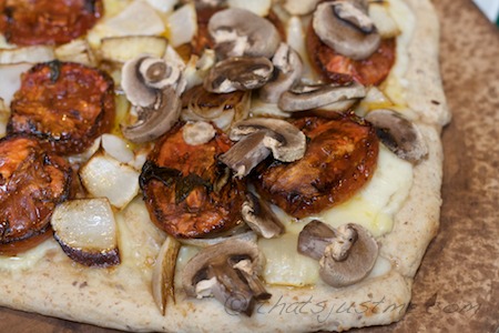 flatbread pizza with roasted tomatoes and onions